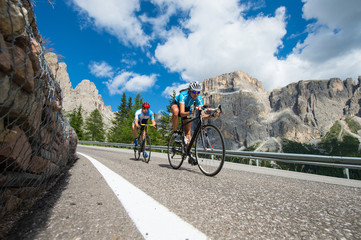 cycle downhill - road cycling man is following woman