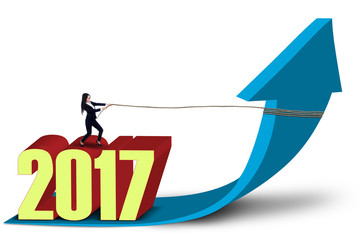 Entrepreneur and numbers 2017 pulling arrow upward