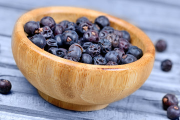 Bamboo bowl with juniper on wooden table