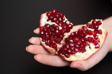 Purified pomegranate fruit in a female hand
