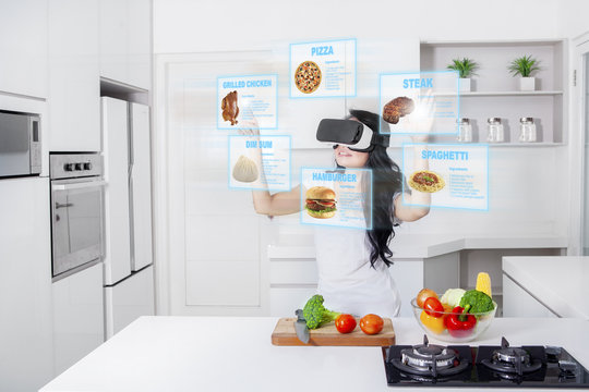 Woman cooking with virtual reality glasses
