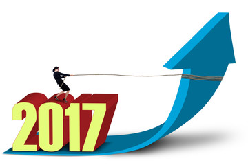 Woman with numbers 2017 pulls arrow