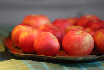 Group of red tasty apples on a plate