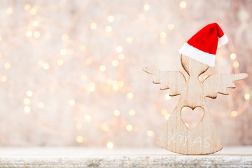 Christmas decor with angel santa hat. Vintages background.