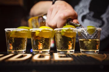 Rolgordijnen Barman schenkt tequila close-up club © Tkachenko Alexey