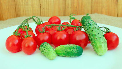 cucumbers and tomatoes on the white plate