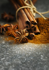 Cinnamon sticks, ground cinnamon and anice, selective focus