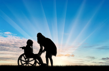 Fototapeta premium Disabled child in wheelchair crying and his mother day