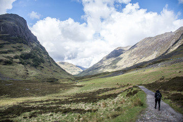 Fototapeta na wymiar Glen Coe Highland scotland girl hiking nature uphill panorama view