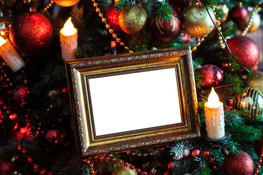 Empty blank photo frame in christmas decorated background with toys and candle lights