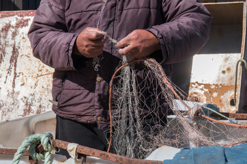 fisherman arranges a fishing net