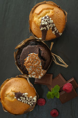 three muffin with raspberries and chocolate