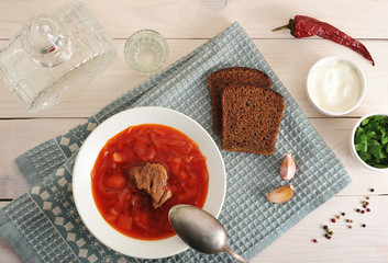 borsch with beef, sour cream and parsley with vodka decanter