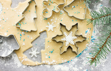 Raw dough for Christmas cookies and cookie cutters