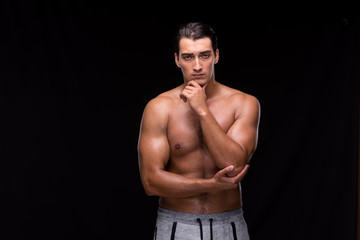 Fototapeta na wymiar Ripped muscular man on black background