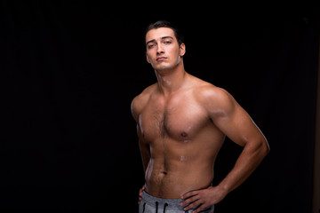 Fototapeta na wymiar Ripped muscular man on black background