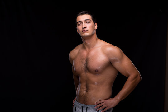 Ripped muscular man on black background