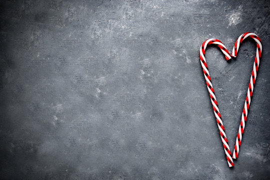Candy cane heart on gray concrete background