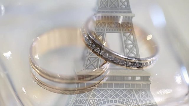 Wedding rings on the Eiffel Tower. Wedding rings lie on the Eiffel Tower. Symbol of Paris.