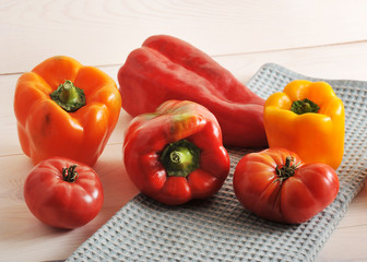 tomatoes and bell peppers on wooden background
