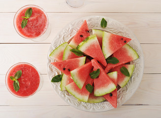 watermelon cutter on the plate and a smoothie of watermelon in g
