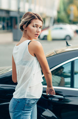 Beautiful gorgeous woman entering a limousine