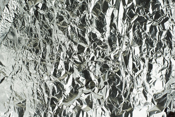 sheet of silver leaf background with shiny crumpled uneven surfa
