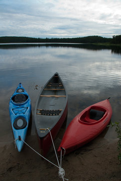 kayaks and canoes moored at shore