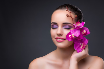 Naklejka premium Young beautiful woman with orchid flower
