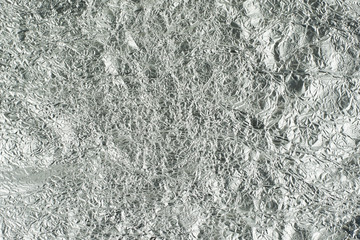 sheet of silver leaf background with shiny crumpled uneven surfa