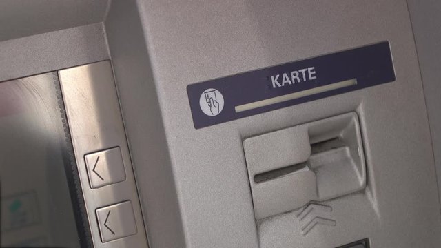 Person withdrawing money from ATM.