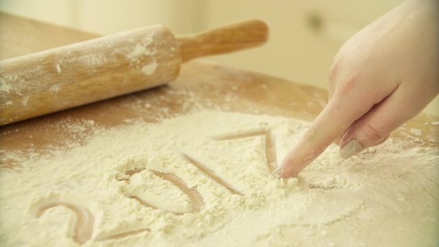 writes 2017. Rolling dough with rolling pin. Chef hands rolling dough ball with dough roller. Baking bread. Men hands rolling dough. Process of forming dough. Woman prepares dough for homemade baking