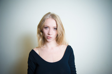 Smirking young blonde woman portrait