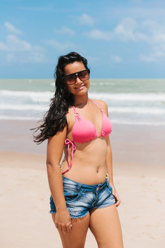 Portrait of young woman wearing a short and bikini on the tropical beach