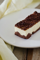 Chocolate Crumble Cheesecake. Slice of cheesecake with chocolate shortcrust pastry and chocolate crumble. Top view