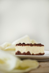 Chocolate Crumble Cheesecake. Yellow linen. Free text space background.