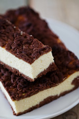 Chocolate Crumble Cheesecake. Slice of cheesecake with chocolate shortcrust pastry and chocolate crumble.