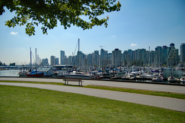 Vancouver skyline with bench and sail boats in harbor