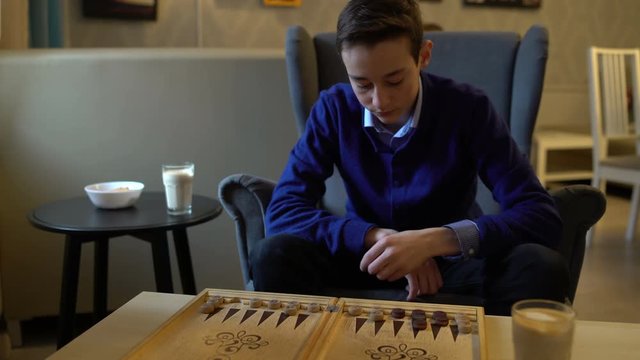 Teenager playing backgammon