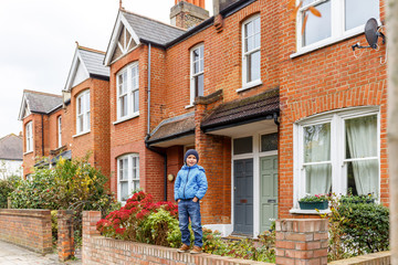 Boy in Chiswick suburb street in autumn, London