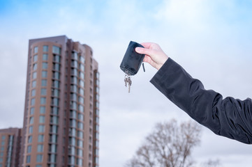 Man's hand holding the keys to a new apartment  