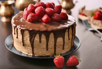 Delicious cake with strawberry on table