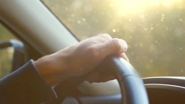 Man driving his car. Man's hand on steering wheel closeup. 1080p HD video footage