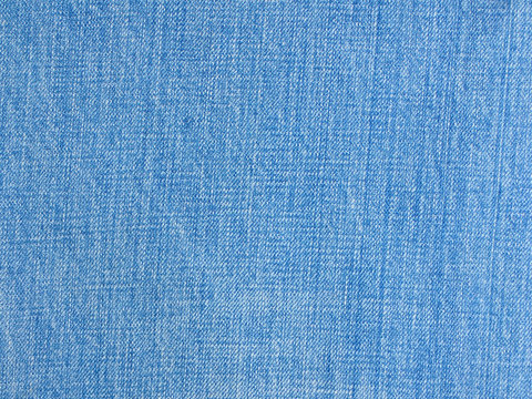 Light blue natural denim texture or blue jeans background