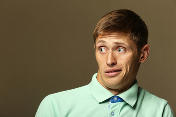 Portrait of young man on colour background