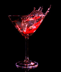 Colorful cocktail with splash on dark background