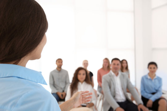 Business trainer giving presentation to group of people
