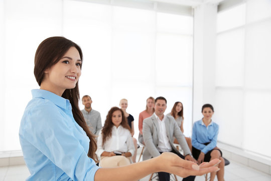 Business trainer giving presentation to group of people