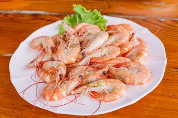 Baked butter shrimp on white dish