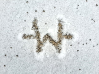 Drawing symbol of money of Korea (Won) on the snow background